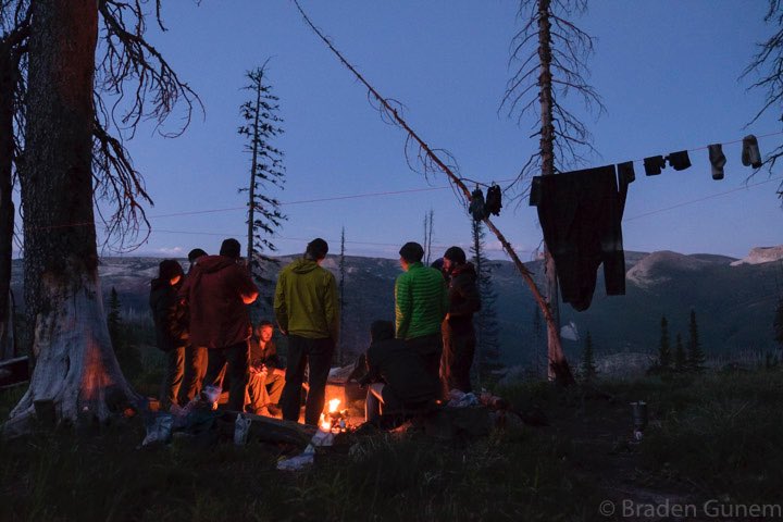 Staying warm with the camp fire at base camp.